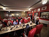 Schülerinnen und Schüler mit Studierenden in einem Restaurant