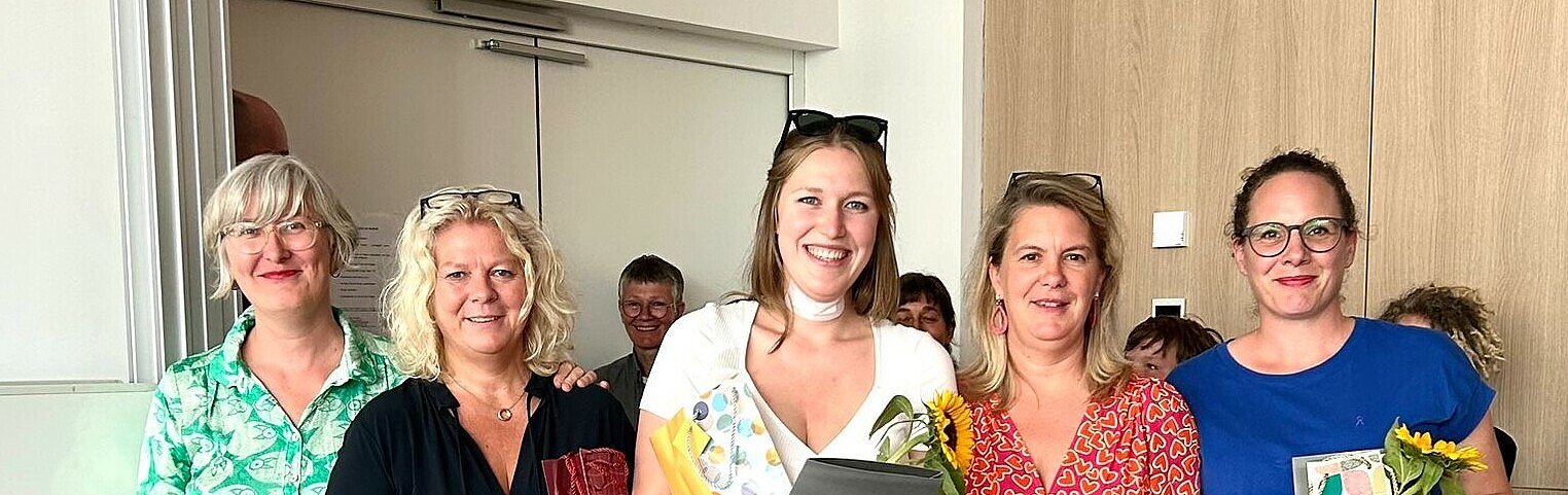 Group picture with four graduates and the head of the degree program