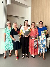 Group picture with four graduates and the head of the degree program